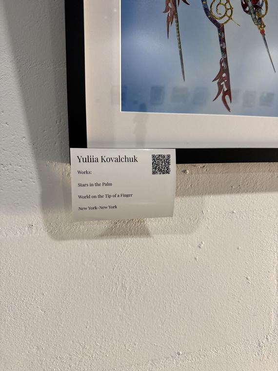 Artist labels with a QR code beside every work